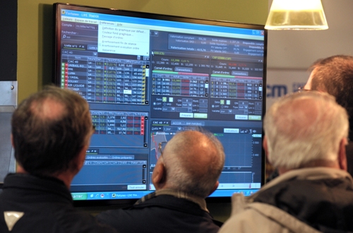 Visitors look at a screen at the French online bank Fortuneo's  stand during the Actionaria shareholders event in Paris on November 23, 2012.   AFP PHOTO / ERIC PIERMONT        (Photo credit should read ERIC PIERMONT/AFP/Getty Images)